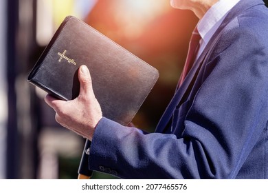 Pastor with a Bible in his hand during a sermon. The preacher delivers a speech - Shutterstock ID 2077465576