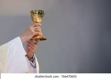 Pastor Hold Wine Glass  In Mass Church. Mass Catholic.