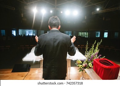 Pastor praying for congregation - Shutterstock ID 742357318