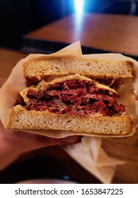 Pastrami Reuben Sandwich On Human Hand