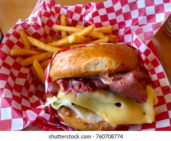 Pastrami Swiss Burger And Fries In A Basket