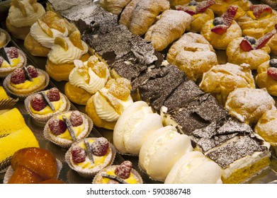 pastries and cakes with decoration, in a pastry - Shutterstock ID 590386748
