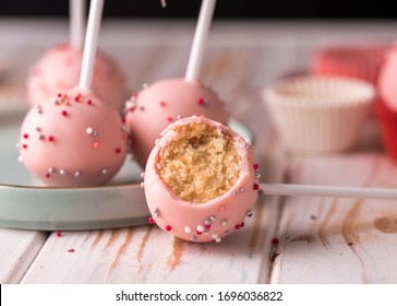 The pastry chef decorates cake pops with satin ribbons. Desserts with pink cream. Tasty food - Powered by Shutterstock