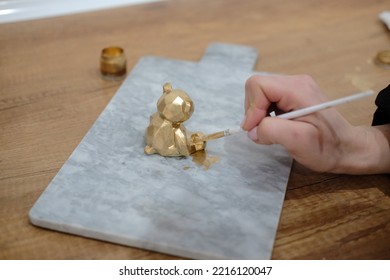 Pastry Chef Hands Draws With A Brush Golden Bear And Horse