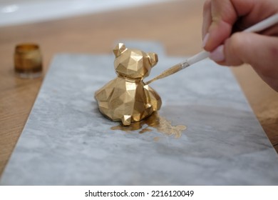 Pastry Chef Hands Draws With A Brush Golden Bear And Horse