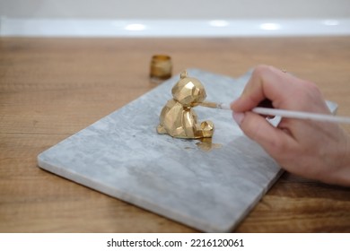 Pastry Chef Hands Draws With A Brush Golden Bear And Horse