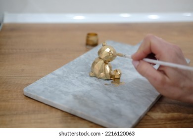 Pastry Chef Hands Draws With A Brush Golden Bear And Horse