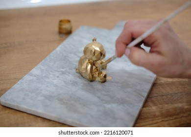 Pastry Chef Hands Draws With A Brush Golden Bear And Horse