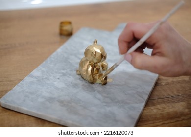 Pastry Chef Hands Draws With A Brush Golden Bear And Horse