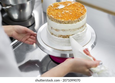 The Pastry Chef Levels The Cake With Cream