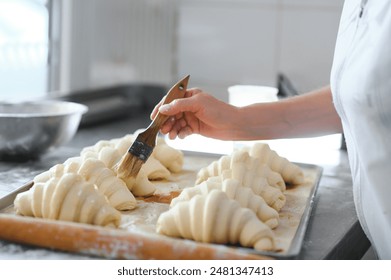 pastry chef making some croissant in the bakery. - Powered by Shutterstock