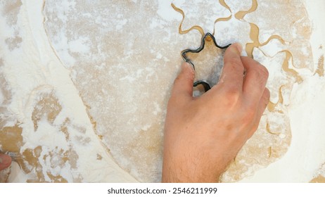 Pastry chef making star shaped cookies using a dough cutter - Powered by Shutterstock