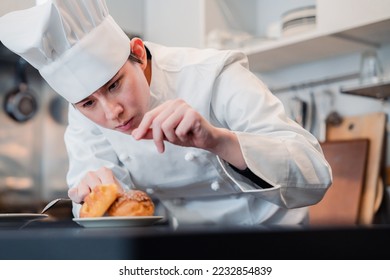 A pastry chef who creates sweets with special attention to detail - Shutterstock ID 2232854839