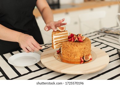 The pastry chef at work. Honey cake. Cake with figs. Cut the cake.
Piece of cake. Honey confectionery.