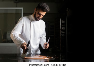 Pastry chef working on tempering chocolate on marble table - Powered by Shutterstock