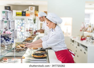 Pastry chefs working in a bar cafeteria