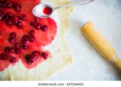 Pastry with cherry rolling on the table. Selective focus.