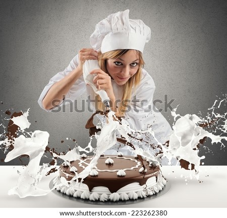 Pastry cook prepares a cake with cream and chocolate