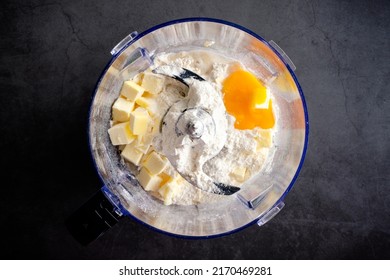 Pastry Dough Ingredients In A Food Processor Bowl: Flour, Butter