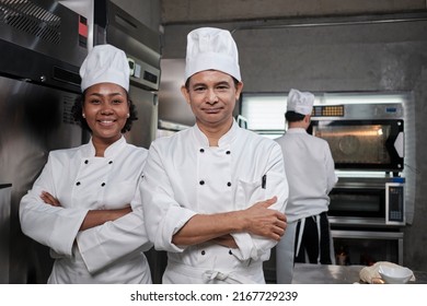 Pastry foods professional partners, two happy chefs team staff in white cooking uniforms stand, arms crossed with confidence, cheerful smiles with commercial culinary jobs in restaurant kitchen. - Powered by Shutterstock