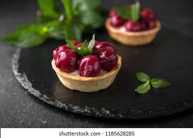 Pastry Tart. Delicate Crispy, Crumbly Dessert With Cherry In Its Own Juice And Mint. Assorted Confectionery Range.