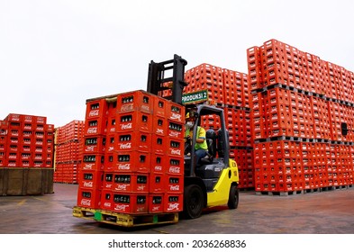 Pasuruan, Indonesia - January 2013 : Forklift truck carries a stack of crates of empty Coca-Cola bottles in factory. 