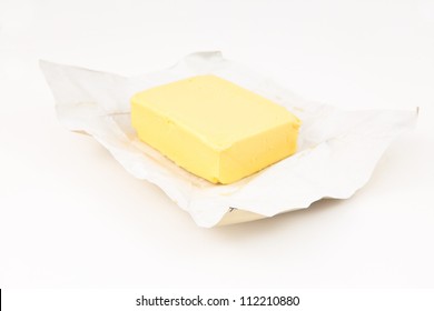 Pat Of Butter Against White Background