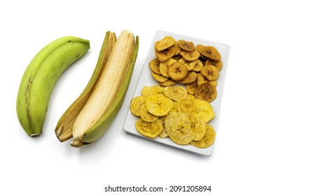 Patacones in white plate and background, recipe of fried green male banana chips - Shutterstock ID 2091205894