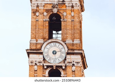  Patarina Tower, a historic architectural landmark, stands prominently in the Campidoglio of Rome. Clock tower featuring a prominent clock, standing tall against a clear sky - Powered by Shutterstock