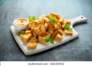 Patatas bravas traditional Spanish potatoes snack tapas on white wooden board