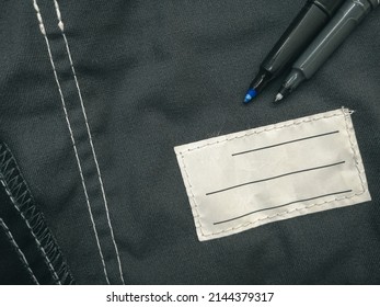 Patch On Work Clothes To Write The Name Of The Owner. Close-up Of A Clean Name Patch. Name Tag. Selective Focus