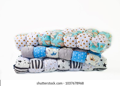 Patchwork And Fashion Concept - Beautiful Stack Of Colorful Quilts, Bedspreads Stacked In Several Rows In Height For Storage, Sale Of Stitched Products On A White Background