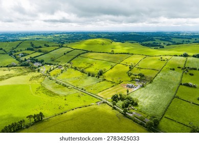 Patchwork fields spread across County Meath, Ireland, under heavy cloud. Peaceful Boyne Valley farming landscape of hedgerows, pasture and rural roads.