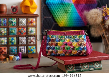Patchwork handbag on the backgroundwooden mini chest with ceramic drawers