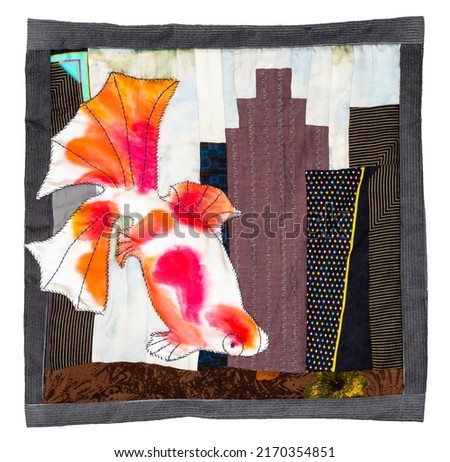 patchwork pillowcase with stitched fish and embroidered cityscape with high-rise houses cutout on white background