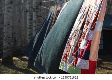 A Patchwork Quilt Hanging On A Clothesline