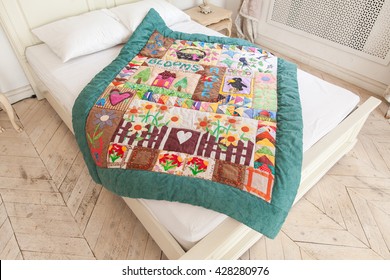 Patchwork Quilt On A White Bed. Part Of Patchwork Quilt As Background. Handmade.