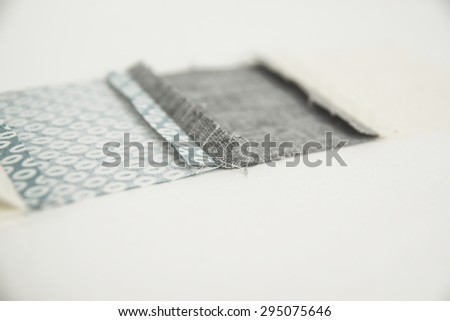 Patchwork sewing technology. Linking pastel cloth patches with cell pattern. Ironing a seam. A reverse side of a work.