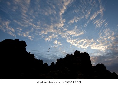 Patchy sky with highline walker in the distance, Joshua Tree National Park - Powered by Shutterstock