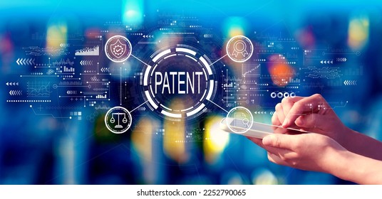 Patent concept with person using a smartphone in a city at night - Shutterstock ID 2252790065