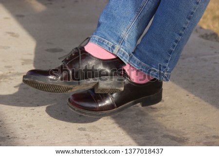 Patent leather shoes with stylish pink socks.