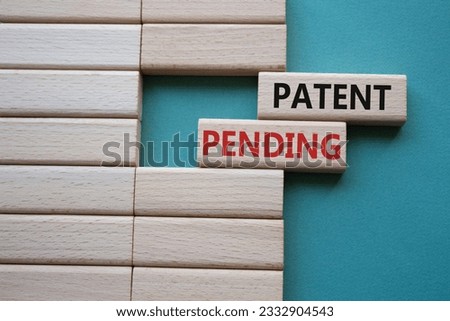 Patent Pending symbol. Concept word Patent Pending on wooden blocks. Beautiful grey green background. Business and Patent Pending concept. Copy space