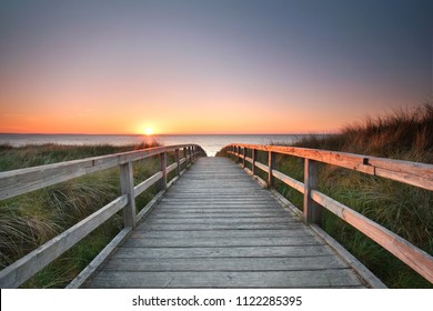 path at Baltic sea over sand dunes with ocean view, sunset summer evening  - Powered by Shutterstock