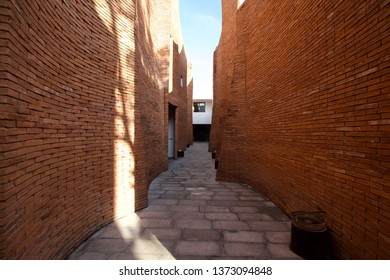 The path between the brown brick wall, brick walls.