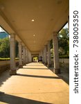Path between colonnade, symbol of unknown and mystery. This architecture is part of the building right in front of Niagara falls. The sunlight creates shadows and strong interesting contrast.