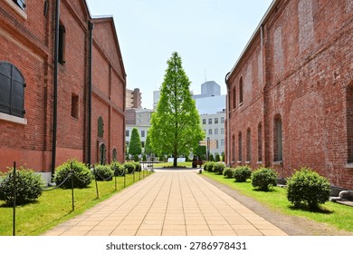 Path between historic red brick warehouse buildings at Noritake no Mori in Nagoya, Japan. 1