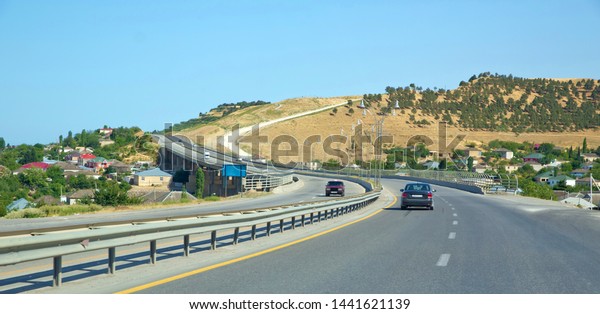 The path to the car. yellow mountains. Road trip,\
fun car ride on desert mountain road in the western countryside.\
Bridge