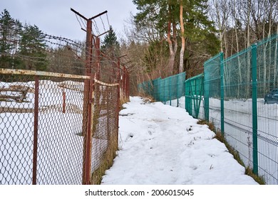 Path covered with snow between twho fences