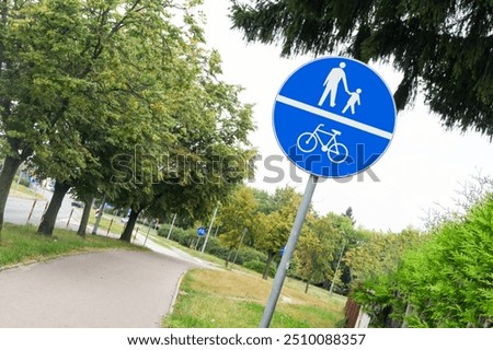 Path for cyclists and pedestrians. Shared spaces in urban environment. Ubran area road safe to walk. Traffic sign isolated. Weekend recreation outdoor background. Recreation walk and cycle path road.