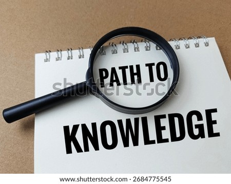 Path to Knowledge Concept with Magnifying Glass on Notebook, Symbolizing Learning, Research, Education, Discovery, Wisdom, Curiosity and Academic Growth. 